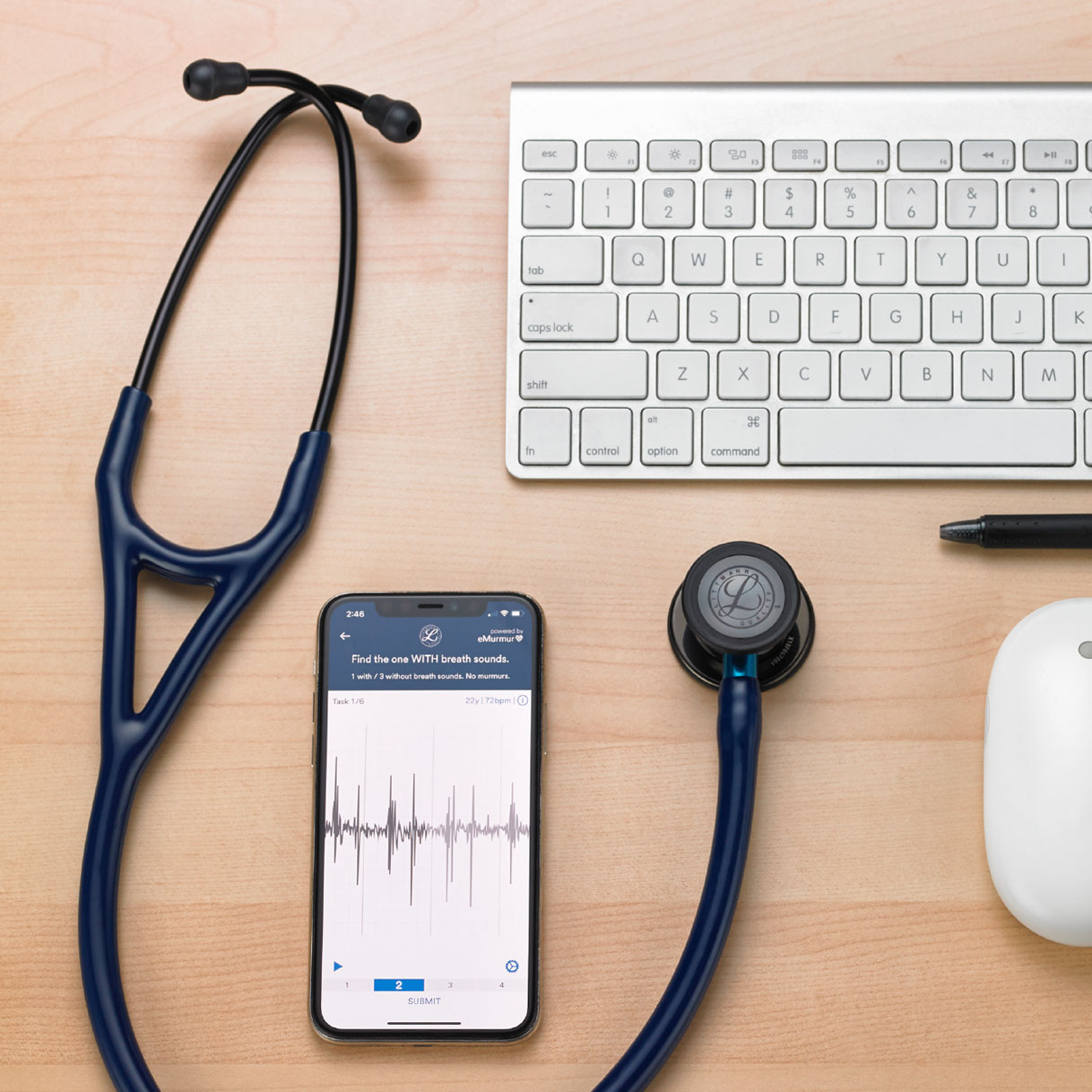 mobile device, keyboard, mouse, and pen on desk with stethoscope