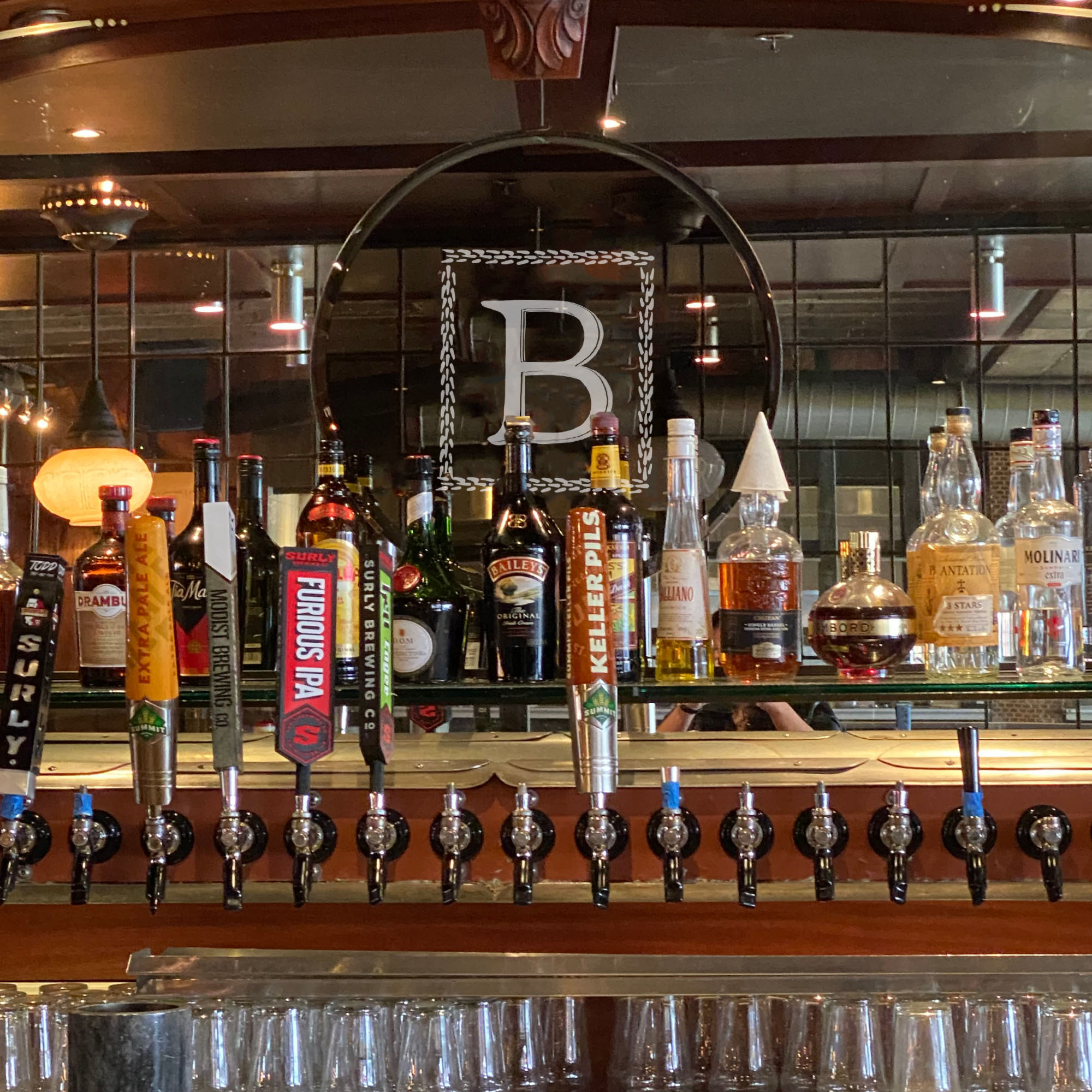 view from behind bar at the butcher's tale of beer taps and liquors
