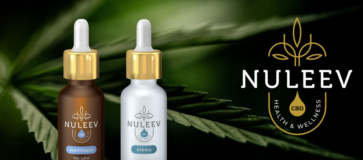 two dropper vials of Nuleev CBD product in front of cannibis leaf with Nuleev logo brand image